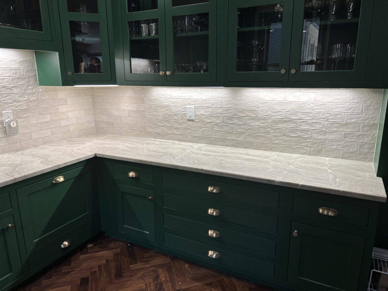 Kitchen with green cabinets and stone countertops